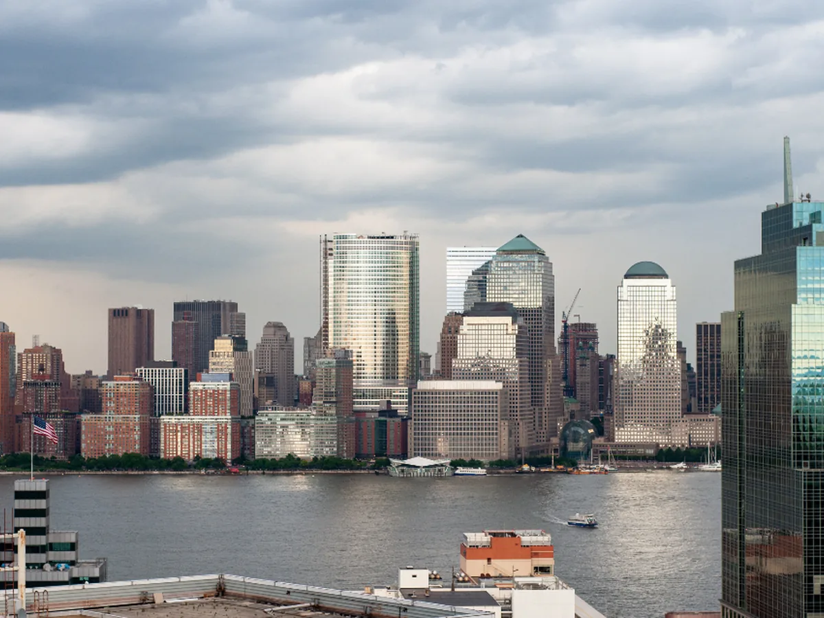 A city financial district skyline seen across the water.