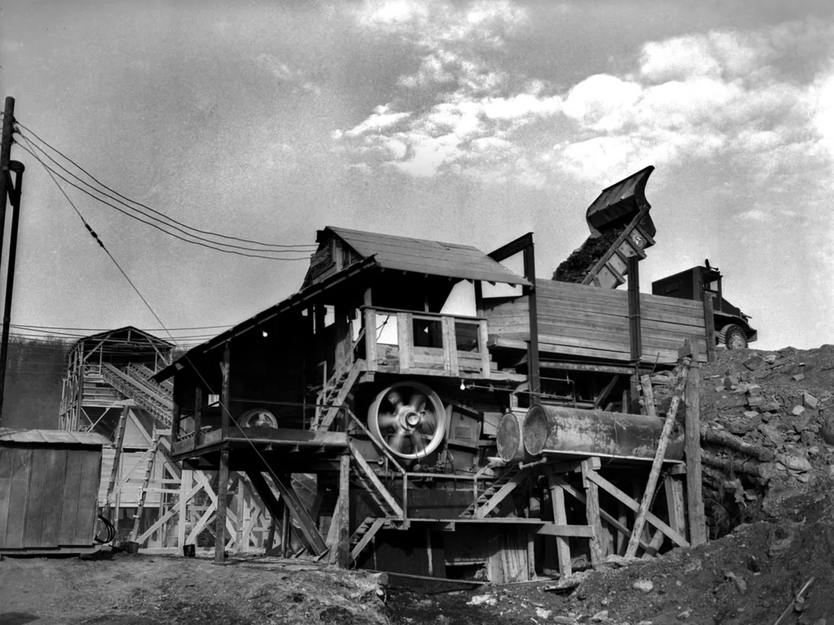 A black-and-white archive photograph of rock-crushing equipment at a quarry.