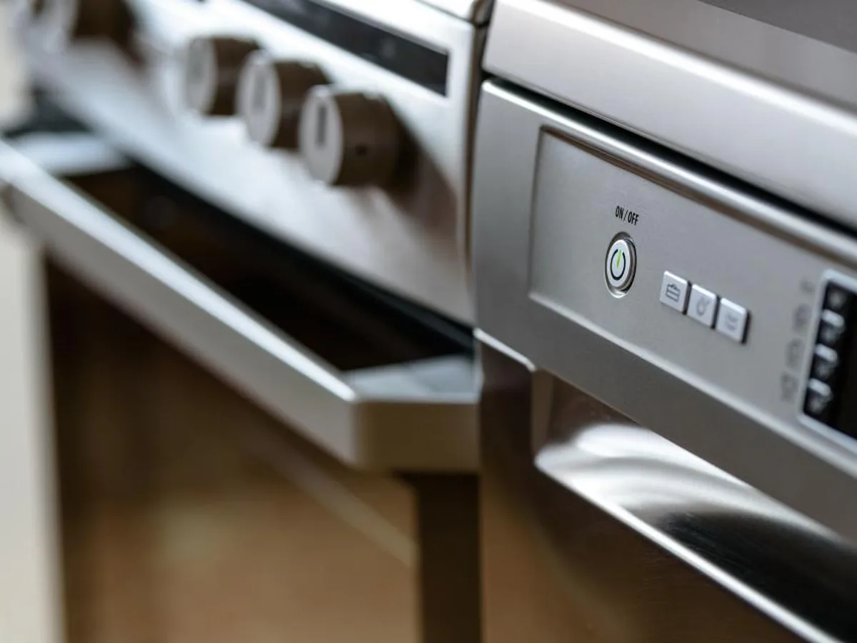 A close-up of a stainless-steel oven and its control panel.