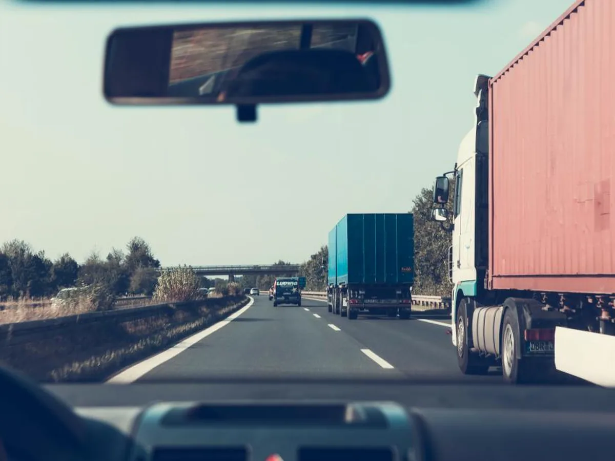 Lorries seen through a windscreen on a motorway.