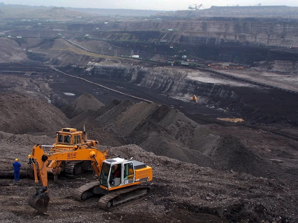 Excavators working on the benches of an open-cast coal mine.