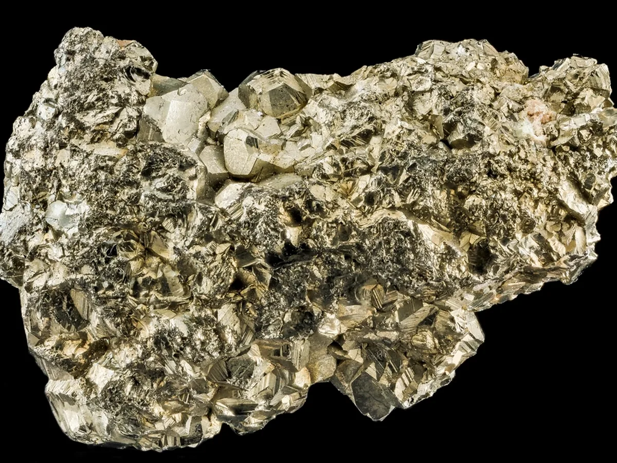 A close-up of a pyrite mineral specimen against a black background.