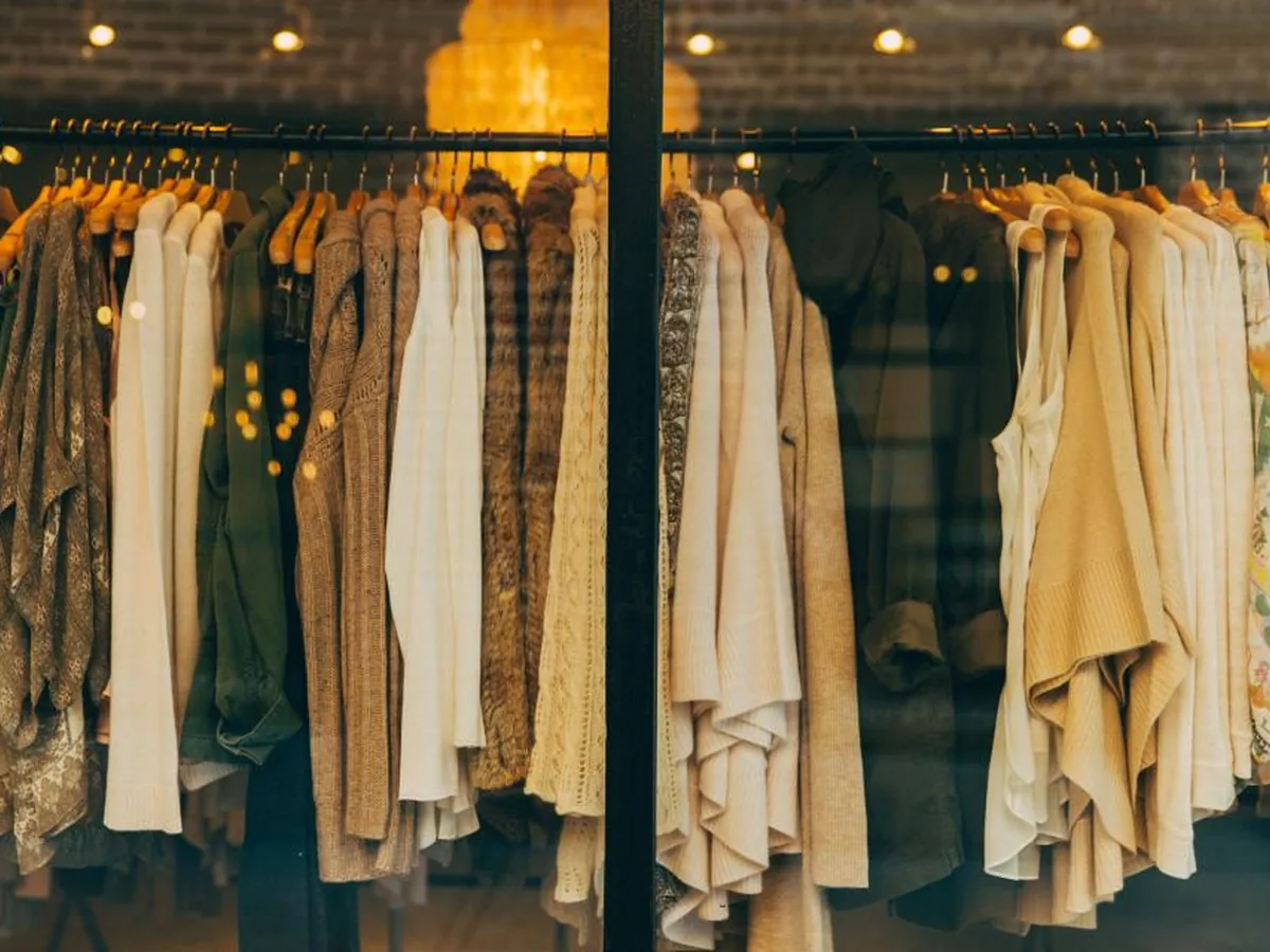 A rail of clothing displayed in a shop.