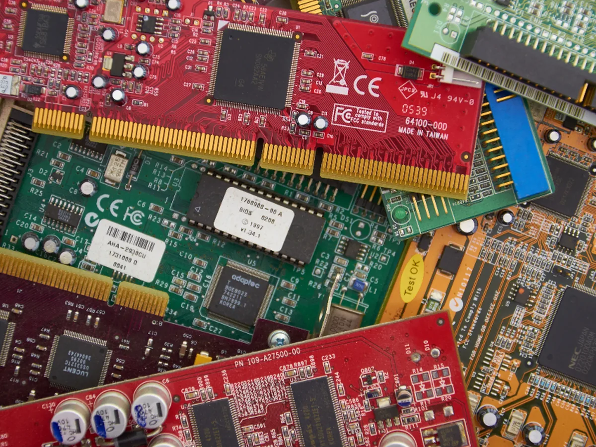 Printed circuit boards and expansion cards piled together.