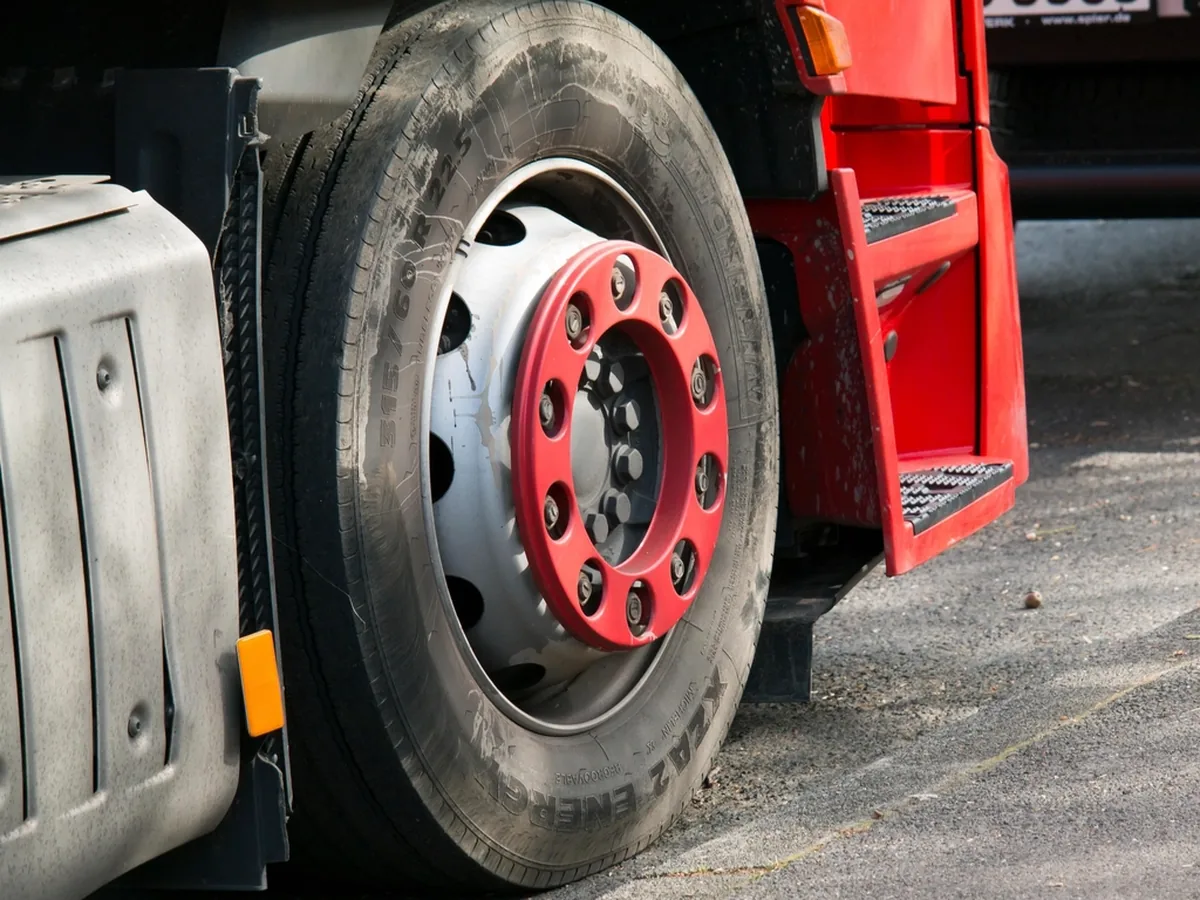 A close-up of a lorry tyre and wheel hub.