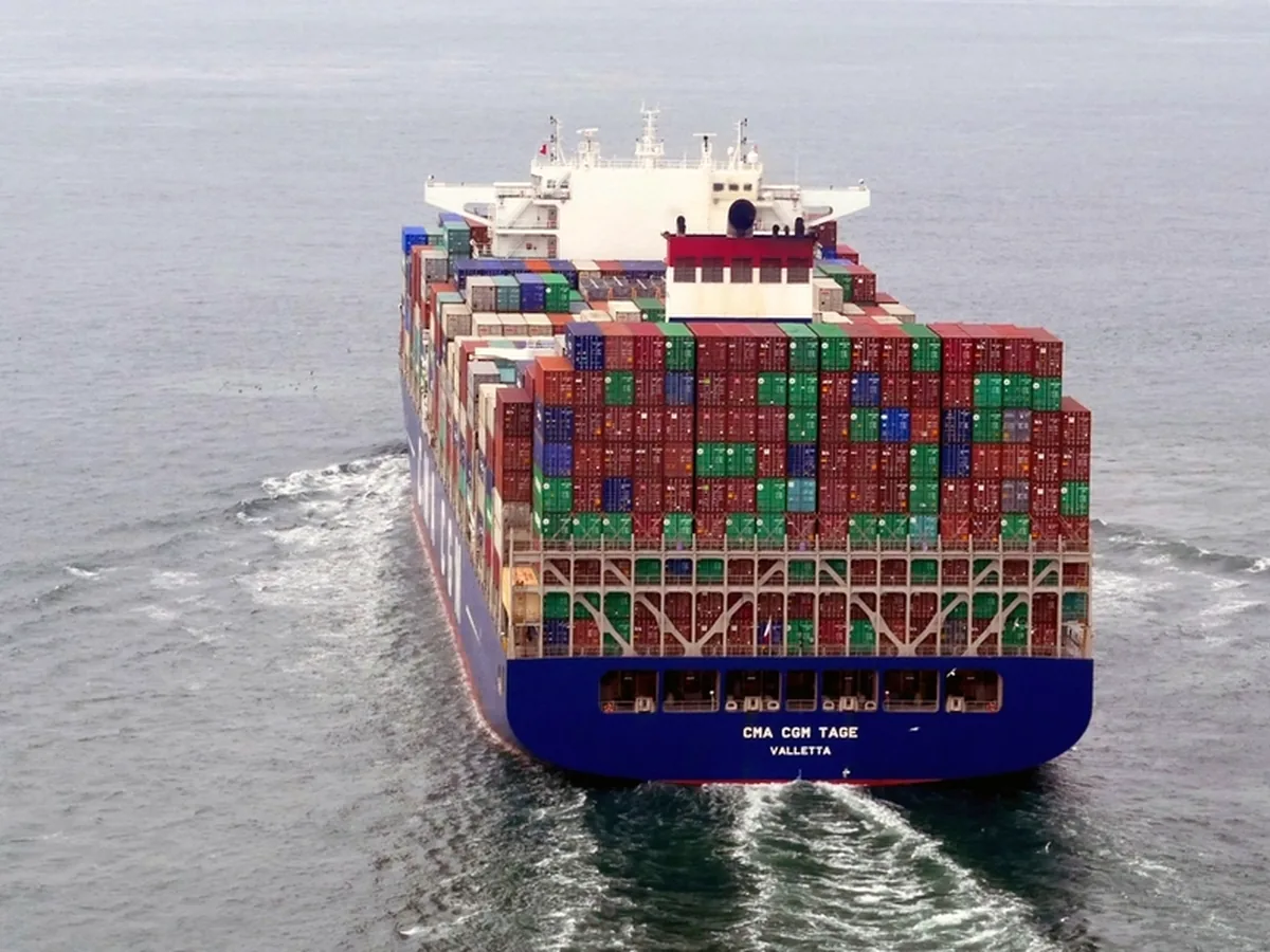An aerial view of a container ship under way at sea.